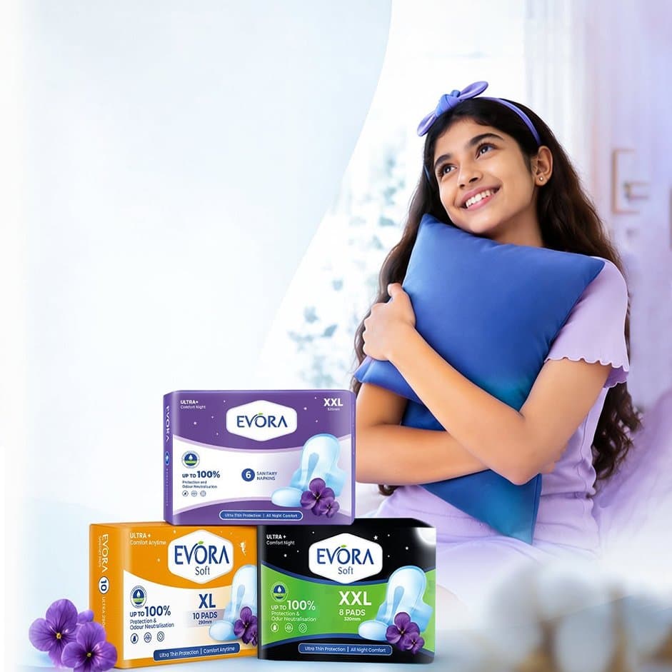 Girl hugging a pillow with Evora Soft sanitary pad packs